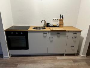 a kitchen with a sink and a counter top at Ferienwohnung mit Balkon in Steinhagen in Steinhagen