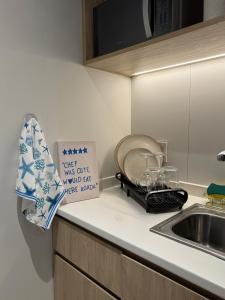 a kitchen counter with a sink and a sign at Escapes in Simpson Bay +3 photos
