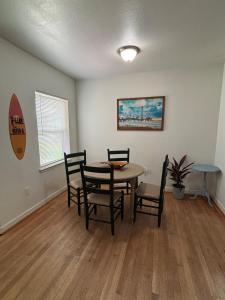 a dining room with a table and chairs at Paradise Surf House in Galveston