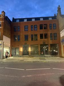 a large brick building on the corner of a street at Luxury 1 Bedroom Apartment sleeps 4 with terrace 10 min to tube in Finchley