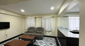 a living room with a couch and a table at Mocheche Apartments Kisii in Gatunga