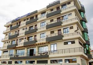 a tall building with balconies on the side of it at Mocheche Apartments Kisii in Gatunga