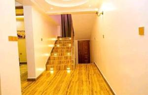 an empty hallway with stairs in a house at Mocheche Apartments Kisii in Gatunga
