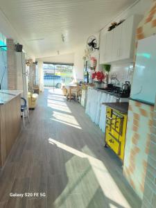 eine Küche mit weißen Schränken und einer Arbeitsplatte in der Unterkunft RECANTO DO SOSSEGO in Palhoça