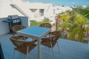 a table and chairs on a balcony with a view at Sunset House Fuerteventura in Villaverde