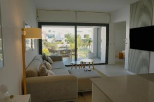 a living room with a couch and a table at Sunset House Fuerteventura in Villaverde