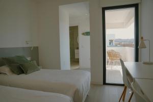 a bedroom with two beds and a view of a balcony at Sunset House Fuerteventura in Villaverde +46 photos