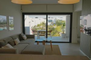 a living room with a couch and a table at Sunset House Fuerteventura in Villaverde