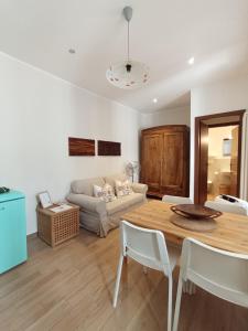 a living room with a table and a couch at Casa Viaemilia in Alessandria
