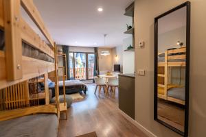 a room with bunk beds and a dining room at Estudio reformado Vall d'Incles Grandvalira, 4 pers, max 2 adultos y 2 niños menores 12 años HUT5840 in Canillo