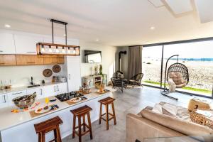 a kitchen and living room with a couch and a table at Dolphin View Beach House in Walvis Bay