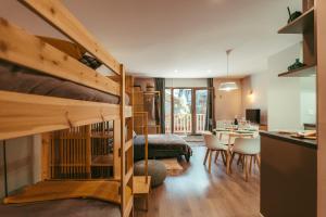 a bedroom with a bunk bed and a dining room at Estudio reformado Vall d'Incles Grandvalira, 4 pers, max 2 adultos y 2 niños menores 12 años HUT5840 in Canillo