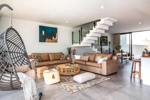 a living room with a couch and a table at Dolphin View Beach House in Walvis Bay