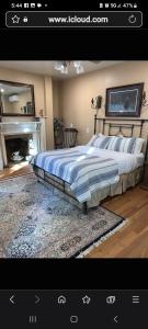 a bedroom with a large bed and a fireplace at Langdon Hill House Felty Room in Gettysburg