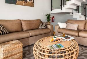 a living room with a couch and a table at Dolphin View Beach House in Walvis Bay