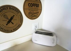 a toaster and a sign on a wall at Dolphin View Beach House in Walvis Bay