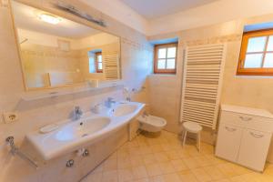 a bathroom with a sink and a toilet at Untergisserhof in Sesto