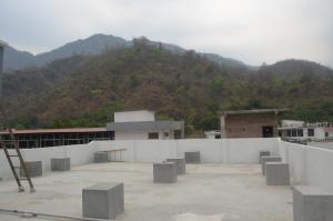 a view of a building with a mountain in the background at The Village in Rishīkesh