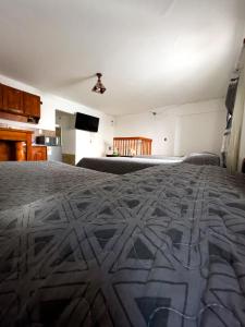a bedroom with a bed with a patterned blanket at TIlcara Rooms in Tilcara