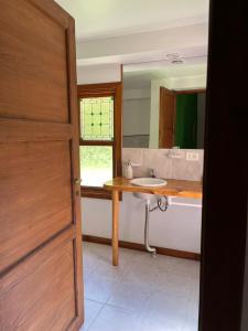 a bathroom with a sink and a mirror at Huala Hosteria in Lago Puelo +76 photos