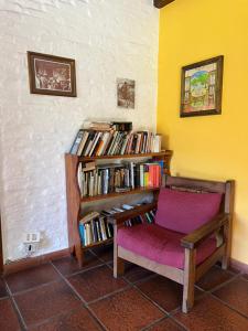 a room with a book shelf filled with books at Huala Hosteria in Lago Puelo