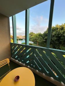 a room with a table and a large window at Le Belvédère - Balcon plein sud au calme in Saint-Pierre-du-Mont
