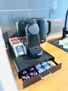 a drawer with a phone and alot of cupcakes at Wellness City Apartment, Infrarotkabine, Top Lage in Bensheim