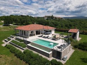 an aerial view of a house with a swimming pool at Villa Green Forest with wellness and heated salty pool in Hum