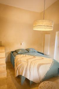 Un dormitorio con una cama y una lámpara y una luz. en Le Charmelan, en Barnas 8 fotos más