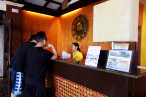 a group of people standing at a counter at a restaurant at Eagle Point Beach and Dive Resort in Mabini +37 photos