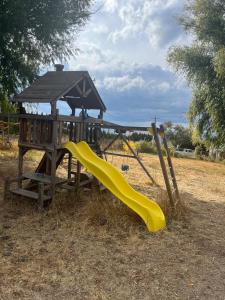 a playground with a yellow slide and a gazebo at Hilltop Orchard Guest Suite with Scenic View in Yakima
