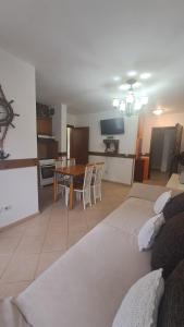 a living room with two beds and a dining room at Golem Green Retreat in Golem