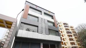 a building with a cross on the side of it at Hotel Darshan Inn in Prayagraj +23 photos