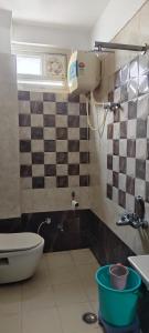 a bathroom with a toilet and a sink at Hotel Darshan Inn in Prayagraj