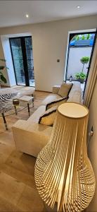 a living room with a couch and a table at Stylish new 2 bedroom apartment in London