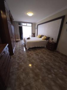 a large bedroom with a bed and a large window at Casa Adora in Santa Ursula im Norden Teneriffas in Santa Úrsula