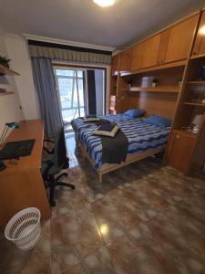 a bedroom with a bed and a desk and a computer at Casa Adora in Santa Ursula im Norden Teneriffas in Santa Úrsula