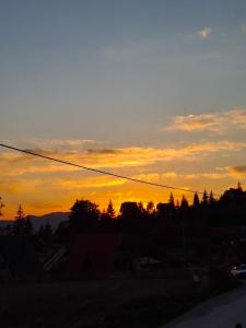 a sunset with the sky in the background at Cozy Cabin in Sekulić 