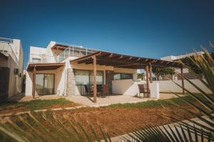 a house with a patio in front of it at Трехкомнатные апартаменты в жилом комплексе Caesar Beach F14 Flat4 in Boğaz