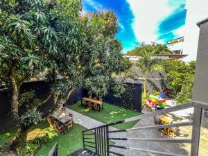 an apartment balcony with a yard with a playground at Antonia Poolside Autonomy Hotel in Ibagué
