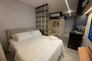 a bedroom with a large white bed in a room at 403 Ocean Art Park - Take Home in Tambaú