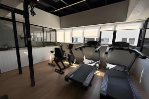 a gym with treadmills and ellipticals in a room with windows at 403 Ocean Art Park - Take Home in Tambaú +14 photos
