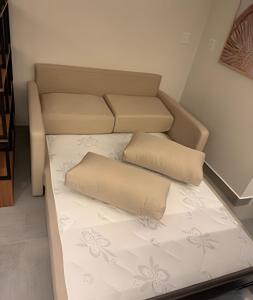 a bed in a room with two pillows on it at 403 Ocean Art Park - Take Home in Tambaú