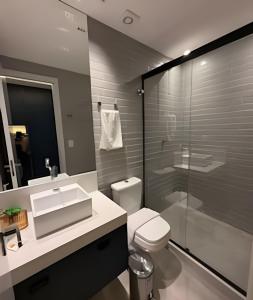 a bathroom with a toilet and a sink and a shower at 403 Ocean Art Park - Take Home in Tambaú