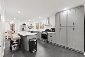 a white kitchen with white cabinets and a counter at Blue Mountain Song- Massanutten Home with Hot tub! in Hopkins Spring