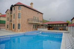 a large swimming pool in front of a building at Qusar Boutique in Qusar