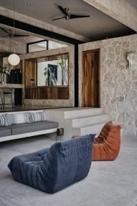 a living room with a blue couch and a stone wall at Casa M in Macario Gomez +43 photos