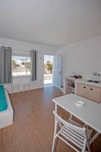 a kitchen and living room with a table and chairs at Marina's House in Tourlos