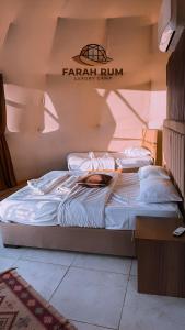 two beds in a room with a sign on the wall at FARAH RUM LUXURY CAMP & Bubbles Hotel in Wadi Rum +80 photos