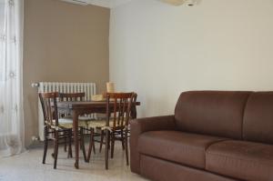 a living room with a table and chairs and a couch at La Casa di Abramo in Venosa